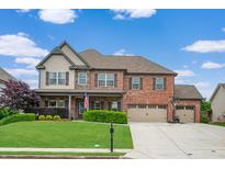 Lovely two-story brick home with a three-car garage and well-manicured lawn at 2470 Day Break Way, Dacula, GA 30019