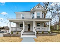 Charming two-story home boasting a spacious front porch and manicured landscaping at 852 Washington Sw St, Atlanta, GA 30315