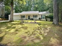 Charming home with a well-manicured lawn and cozy front porch at 520 Cranberry Pl, Roswell, GA 30076