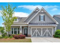 Charming one-story home with grey siding, manicured landscaping, and a welcoming two-car garage at 427 Bluffs View Ln, Canton, GA 30114
