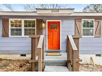 Charming home featuring an orange front door, window shutters, and an inviting front porch at 2608 Barge Sw Rd, Atlanta, GA 30331