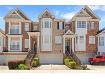 Charming townhomes featuring brick facade, individual garages, and manicured landscaping in a desirable neighborhood at 1266 Creekside Se Ter, Smyrna, GA 30082