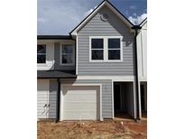 New construction home with a one-car garage and light-blue siding at 11618 E Lovejoy Rd, Hampton, GA 30228