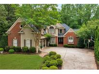 Charming two-story home with landscaped yard, driveway, and beautiful curb appeal at 1477 Edenham Ln, Cumming, GA 30041