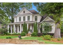 Charming two-story home with manicured lawn, brick accents and inviting front porch at 194 Locust Nw St, Marietta, GA 30064