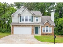 Charming two-story home with stone accents, a well-manicured lawn, and an attached two-car garage at 3514 Willgrove Way, Duluth, GA 30096