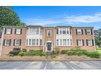 Charming brick townhouse with black shutters, trimmed windows and well-kept landscaping at 2349 Henderson Mill Ne Rd # 2, Atlanta, GA 30345