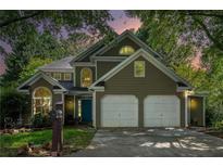 Charming two-story home boasts lush landscaping, a two-car garage, and a welcoming front entrance at 2735 Royal Blf, Decatur, GA 30030