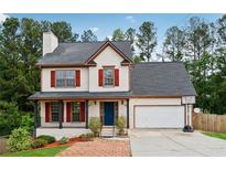 Charming two-story home with red shutters, covered porch, brick walkway, and attached two-car garage at 3055 Kennesaw Nw Dr, Kennesaw, GA 30152
