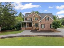 Beautiful two-story brick home with manicured lawn and stone accents on a sunny day at 18 Starlight Dr, Cartersville, GA 30121