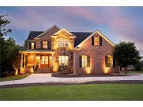 Charming brick home featuring stone accents, a welcoming porch and professional landscaping at 18 Starlight Dr, Cartersville, GA 30121