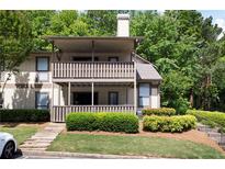 Two-story condo with double decks and steps leading up to a well-manicured lawn and mature trees at 807 Woodcliff Dr, Sandy Springs, GA 30350