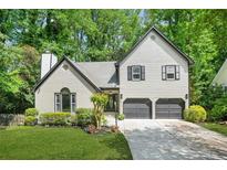 Charming two-story home with a landscaped front yard and a two-car garage at 1810 Fairoaks Pl, Decatur, GA 30033