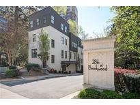 Modern townhome featuring a brick facade, dark trim, and professional landscaping, located at 28th at Brookwood at 1821 Huntington Hills Nw Ln, Atlanta, GA 30309