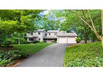 Charming two-story home with a well-maintained lawn and a two-car garage at 1665 Chevron Way, Sandy Springs, GA 30350
