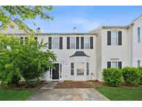 Charming two-story townhome featuring black shutters, a bay window and a well-manicured lawn at 115 Benfield Cir, Cartersville, GA 30121
