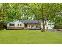 Charming ranch style home with a well-manicured lawn and inviting front porch with wood columns at 2221 Meadow Wood Ct, Marietta, GA 30062
