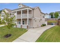Charming two-story home featuring a double balcony, well-manicured lawn, and a long driveway at 2342 Terrace View Sw Cir, Atlanta, GA 30315