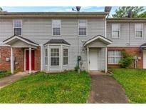 Charming townhouse with brick accents and covered entryway, offering a cozy and inviting curb appeal at 8541 Westchester Dr, Douglasville, GA 30134