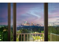 View of city skyline at dusk from home's large windows at 250 Pharr Ne Rd # 716, Atlanta, GA 30305