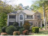 Traditional two-story home with manicured landscaping and mature trees in the front yard at 3643 Fowler Rdg, Douglasville, GA 30135