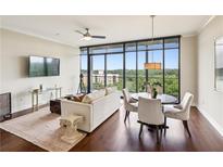 Bright living room with hardwood floors, large windows, and comfortable seating area at 2233 Peachtree Ne Rd # 903, Atlanta, GA 30309