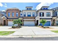 View of three townhouses showcasing individual design and a shared driveway at 240 Walker Avenue, Roswell, GA 30076