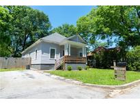 Charming single-story home featuring a cozy front porch and a well-maintained yard at 3273 Elm St, Atlanta, GA 30337