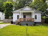 Charming home featuring a covered front porch and fresh landscaping at 3273 Elm St, Atlanta, GA 30337