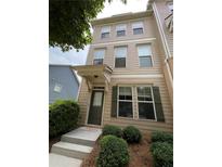 Charming townhouse featuring a welcoming entrance and well-maintained landscaping at 790 Village Field Ct, Suwanee, GA 30024