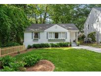 Charming white home featuring a manicured front yard, grey shutters and window boxes at 2316 Hurst Ne Dr, Atlanta, GA 30305
