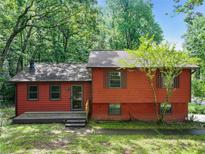 Charming split-level home with wooded surroundings and inviting front porch at 2420 Leaf Land Dr, Duluth, GA 30097
