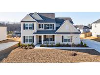 Charming two-story home with a well-manicured lawn and a welcoming front porch at 807 Parker Pass, Peachtree City, GA 30269