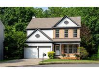 Charming two-story home with a well-maintained lawn, brick accents, and an attached two-car garage at 3260 Ridgefair Dr, Cumming, GA 30040