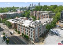 A nice aerial view of the apartment building with its well-maintained facade, featuring a mix of gray and brick elements at 660 Glen Iris Dr # 206 & 109, Atlanta, GA 30308