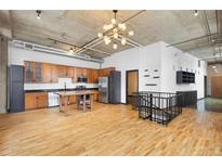 Open kitchen features modern cabinets, stainless steel appliances, and a large wooden island at 660 Glen Iris Dr # 206 & 109, Atlanta, GA 30308