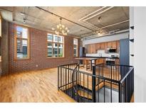 Bright living space with exposed brick, hardwood floors, and an open kitchen with stainless steel appliances at 660 Glen Iris Dr # 206 & 109, Atlanta, GA 30308