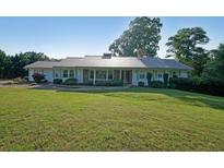 Beautiful ranch-style home featuring a metal roof, stone accents, and a spacious front yard at 1001 Wiley Bridge Rd, Woodstock, GA 30188