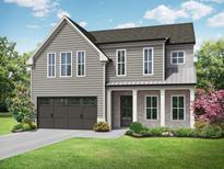 Beautiful two-story home with gray siding, a covered porch, manicured landscaping, and an attached two car garage at 5627 Meadowstone Walk, Kennesaw, GA 30152