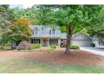 Charming two-story home with well-maintained landscaping and a welcoming front porch at 2285 Ashton Ridge Dr, Dacula, GA 30019