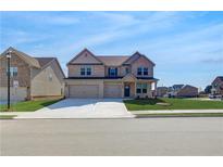 Attractive two-story brick home featuring a three-car garage, manicured lawn, and inviting curb appeal at 2447 Cadenza Cir, Dacula, GA 30019
