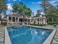Stunning pool and patio area with lush landscaping surrounding the backyard of the beautiful home at 3625 Tuxedo Nw Rd, Atlanta, GA 30305