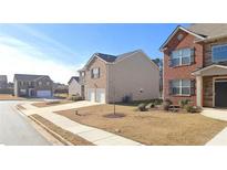 Charming homes with manicured lawns line a peaceful street at 11562 Creekstone Rd, Hampton, GA 30228