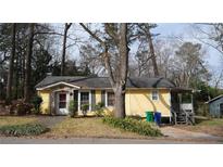 Charming single-story house with a covered porch and a cozy, welcoming facade in a wooded neighborhood at 4622 Dogwood Rd, Pine Lake, GA 30072