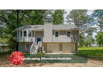 Two story home featuring a two car garage, landscaping allowance and front porch with stairs at 180 Old Airport Rd, Carrollton, GA 30116