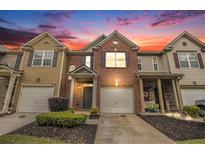 Charming townhome with brick and siding exterior, featuring a one-car garage and well-maintained landscaping at 3364 Thornbridge Dr # 0, Powder Springs, GA 30127