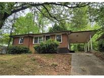 Charming single-story home with a covered carport and traditional brick facade at 767 Vinson Pl, Atlanta, GA 30315