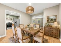 This dining room has beautiful light fixture, a lovely wood table set for six, and a hutch at 2300 Newport Lndg, Alpharetta, GA 30009