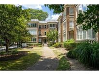 Beautiful brick apartment building featuring manicured landscaping and a charming walkway at 272 14Th St # 23, Atlanta, GA 30309
