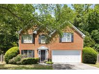 Charming two-story brick home with well-manicured landscaping and a two-car garage in a desirable neighborhood at 5404 Trumpet Vine Se Trl, Mableton, GA 30126